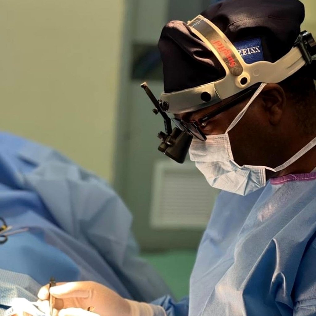 Chief Ophthalmic Surgeon operating with Zeiss surgical loupes and instruments at Lusaka Eye Hospital